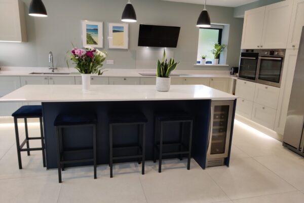 white kitchen with blue island